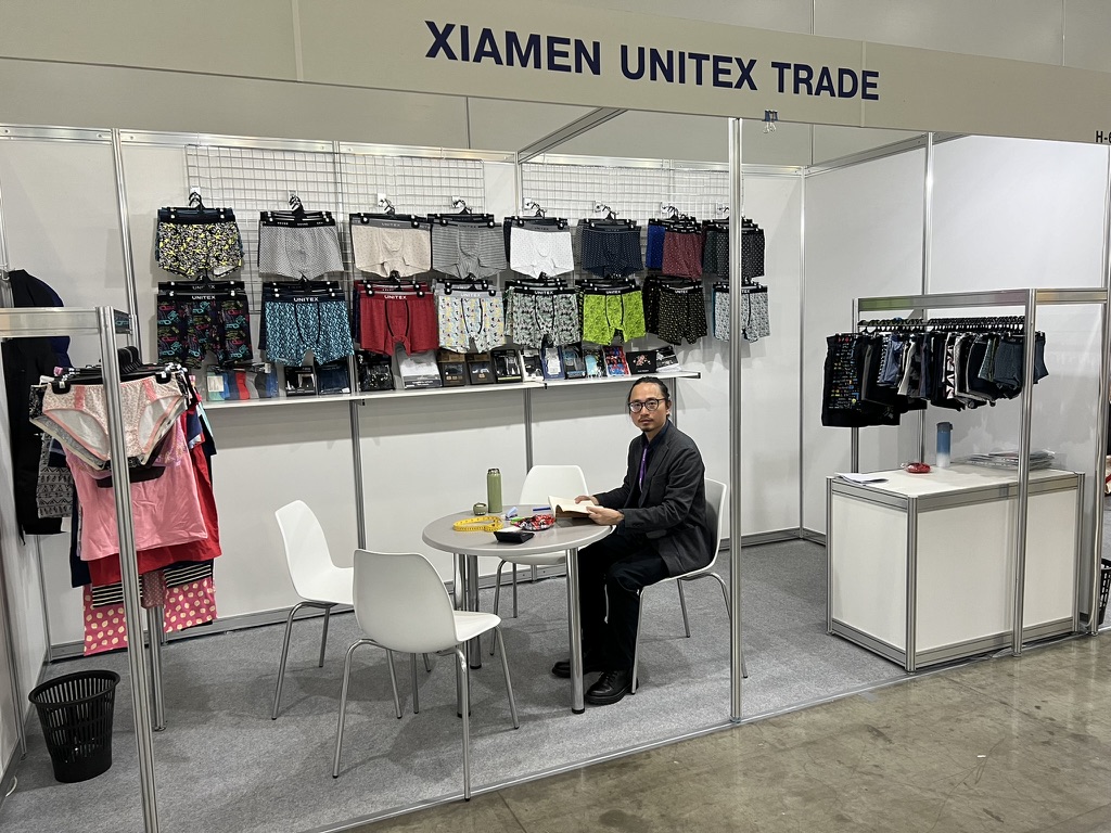 Unitex booth at the trade fair — Will Lin at the stand