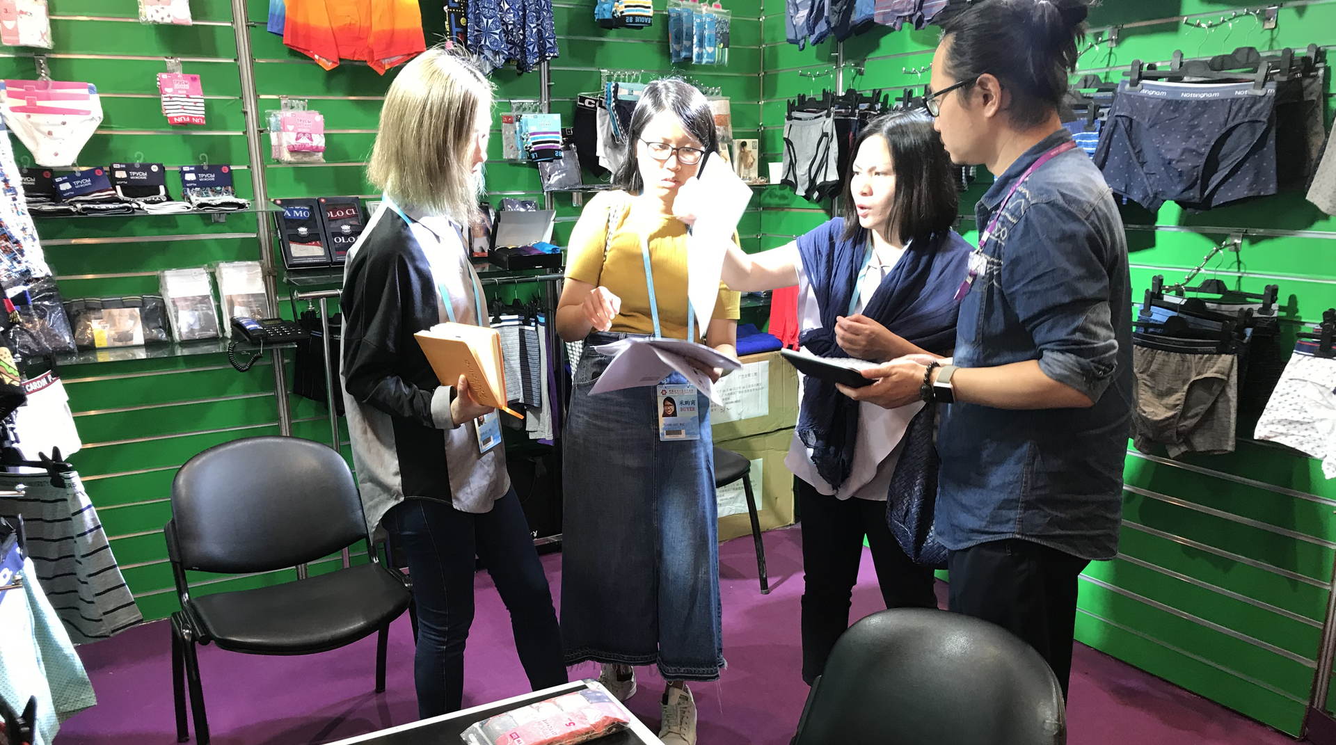 Unitex founder Will Lin meeting buyers at the company's Canton Fair booth, underwear samples on display